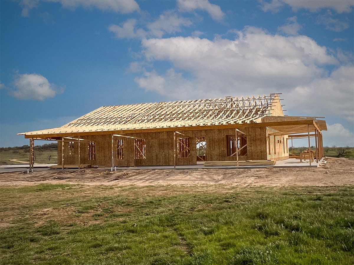 Wide-angle view of B&M Home Builders project with exposed roof trusses