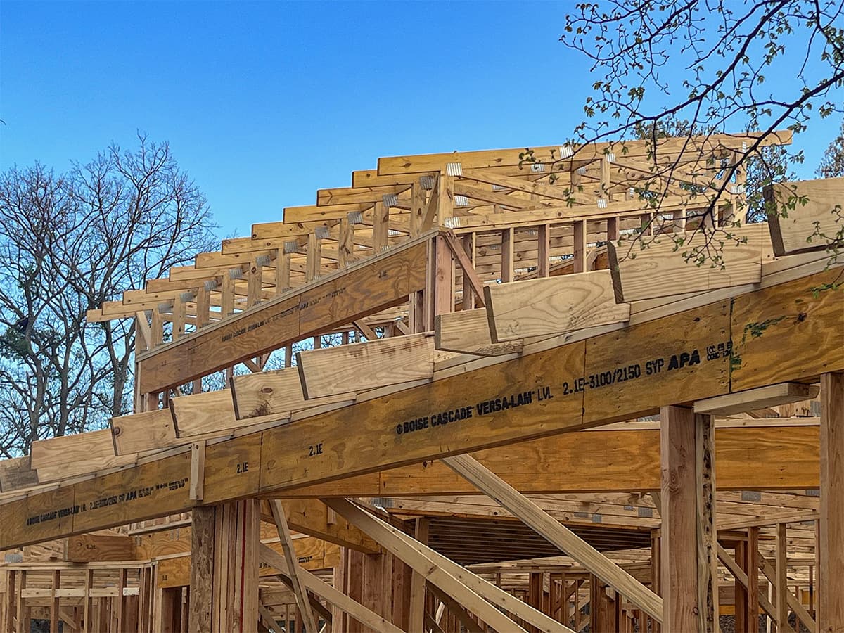 Framing stage of lakehouse project with roof trusses installed