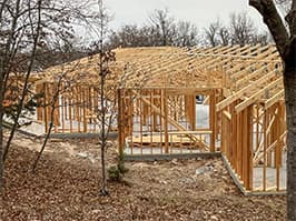 Framing stage of lakehouse project with roof trusses installed