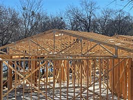 Framing stage of lakehouse project with roof trusses installed