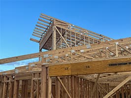 Framing stage of lakehouse project with roof trusses installed