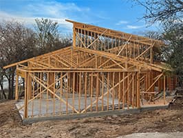 Framing stage of lakehouse project with roof trusses installed