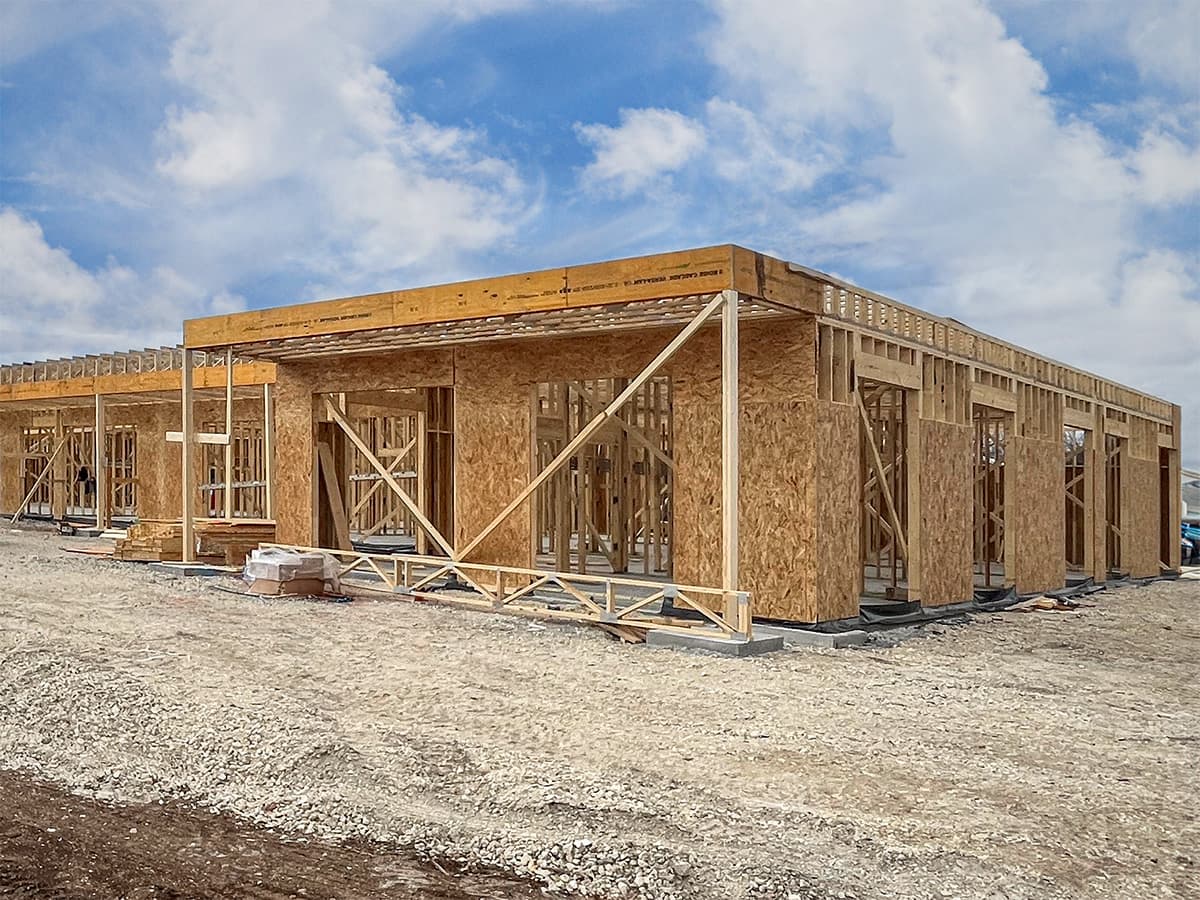 Wide-angle view of office building project with roof trusses installed