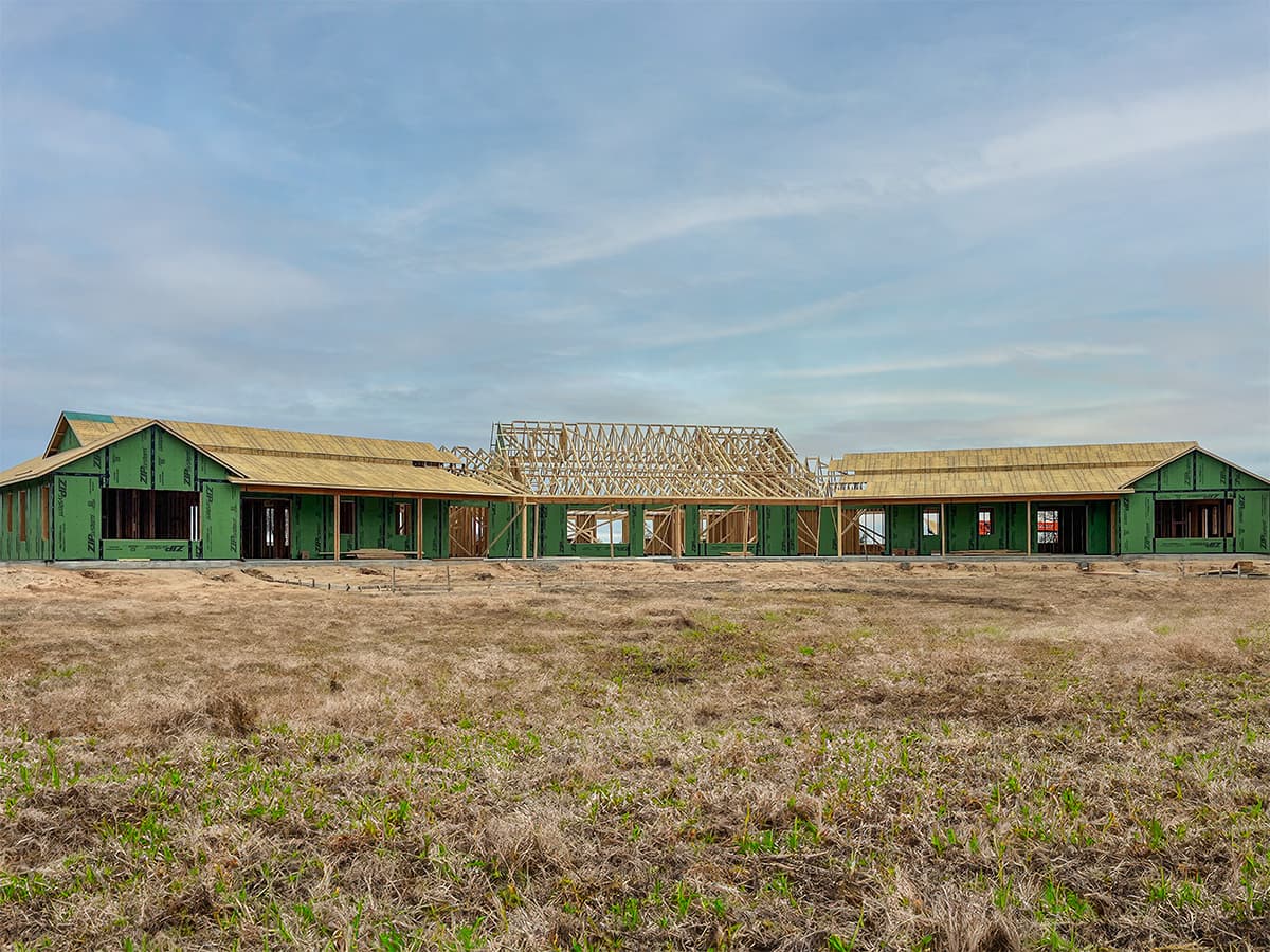 Wide-angle view of staff housing project with some exposed roof trusses