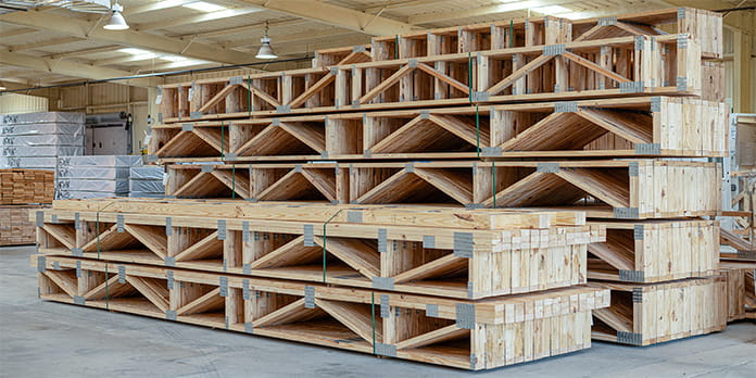 Assembled and stacked custom floor trusses ready to be delivered